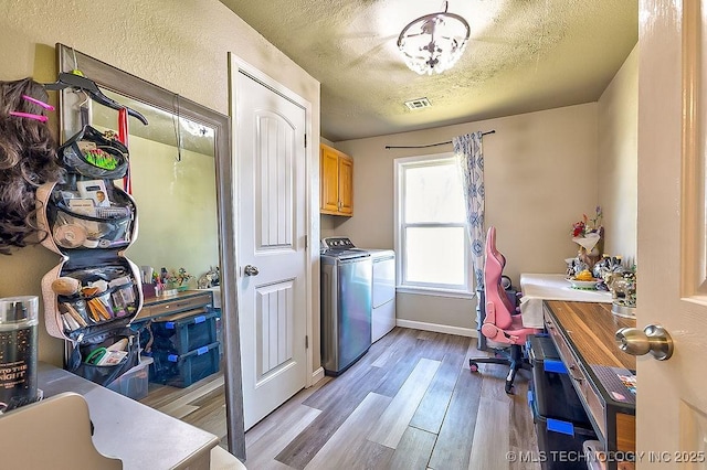 7008 S Hwy 28, Chelsea, OK 74016 - laundry area with cabinet space, independent washer and dryer, light wood-style floors, an office area, and a textured ceiling