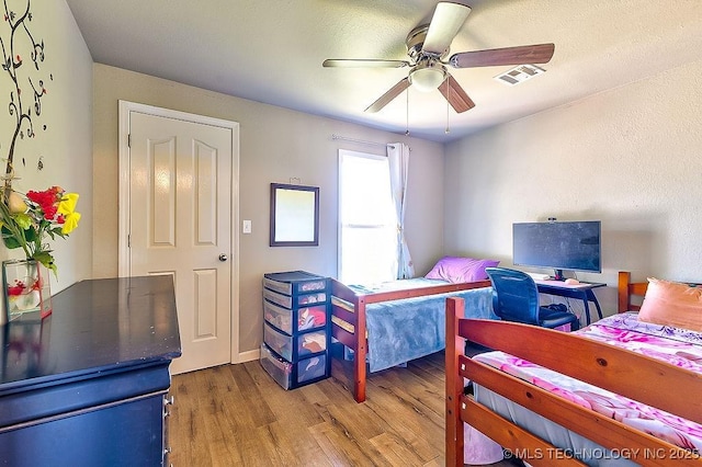 7008 S Hwy 28, Chelsea, OK 74016 - bedroom with wood finished floors and a ceiling fan