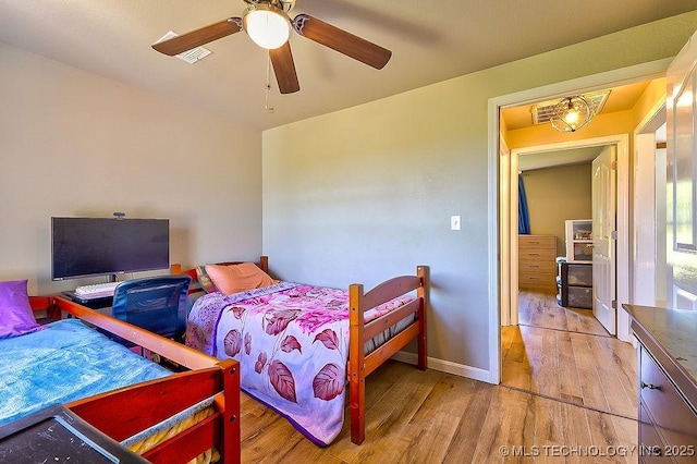 7008 S Hwy 28, Chelsea, OK 74016 - bedroom with wood finished floors and ceiling fan