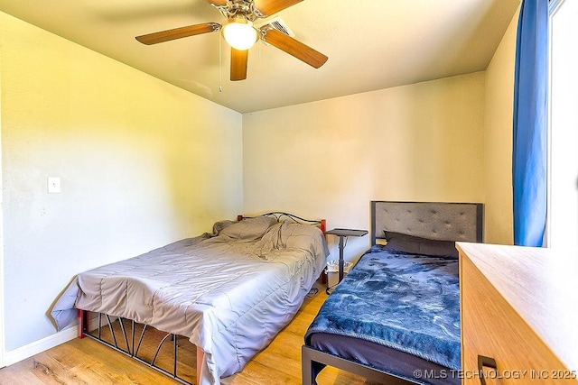 7008 S Hwy 28, Chelsea, OK 74016 - bedroom with wood finished floors, baseboards, and ceiling fan