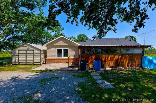 7008 S Hwy 28, Chelsea, OK 74016 - rear view of house with brick siding, a patio area, and a yard