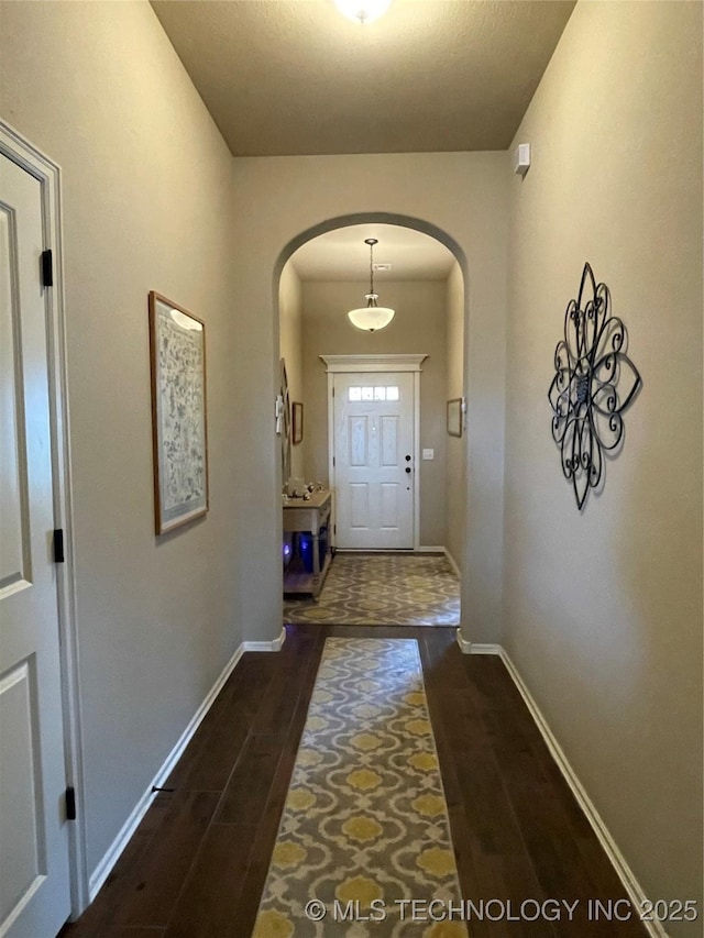 2613 W Van Buren Ct, Broken Arrow, OK 74011 - doorway with arched walkways, dark wood-style floors, and baseboards