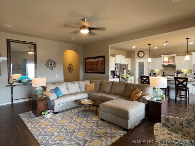 2613 W Van Buren Ct, Broken Arrow, OK 74011 - living room featuring ceiling fan, arched walkways, and dark wood-type flooring