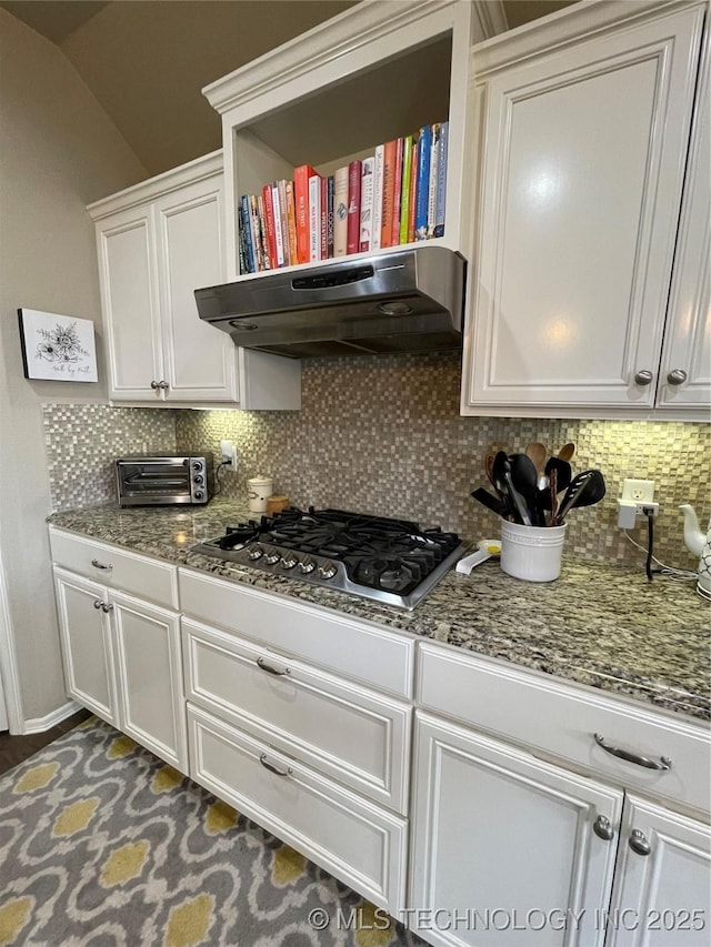 2613 W Van Buren Ct, Broken Arrow, OK 74011 - kitchen with stainless steel gas cooktop, decorative backsplash, white cabinets, under cabinet range hood, and vaulted ceiling