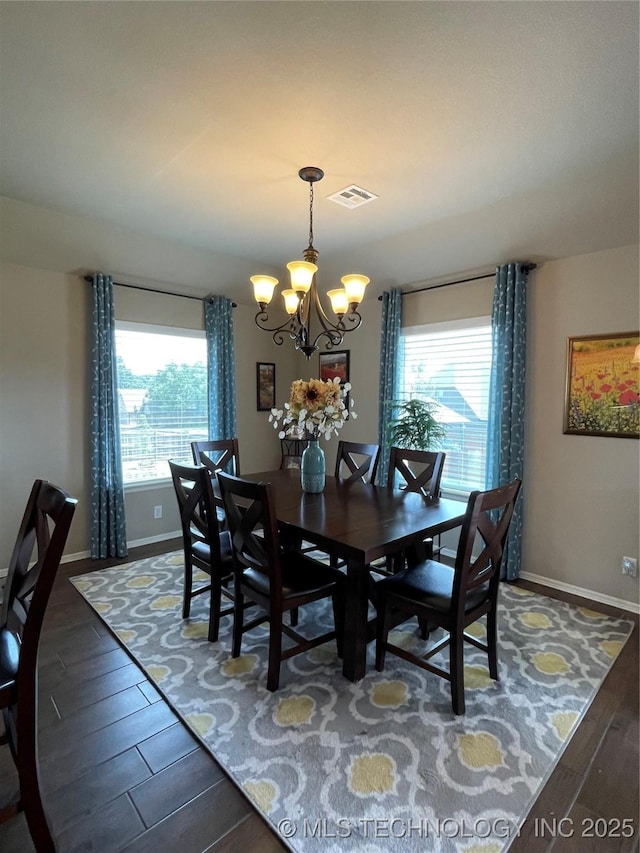 2613 W Van Buren Ct, Broken Arrow, OK 74011 - dining area with a chandelier, wood finished floors, and baseboards