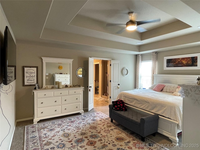 2613 W Van Buren Ct, Broken Arrow, OK 74011 - carpeted bedroom with a tray ceiling, baseboards, and a ceiling fan