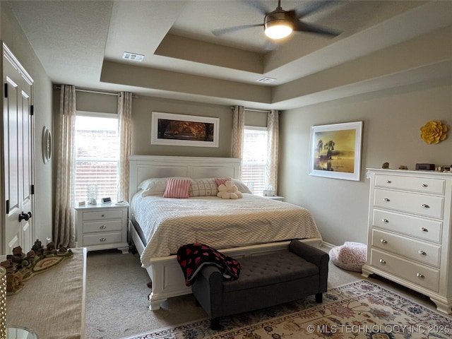 2613 W Van Buren Ct, Broken Arrow, OK 74011 - carpeted bedroom featuring a raised ceiling and a ceiling fan