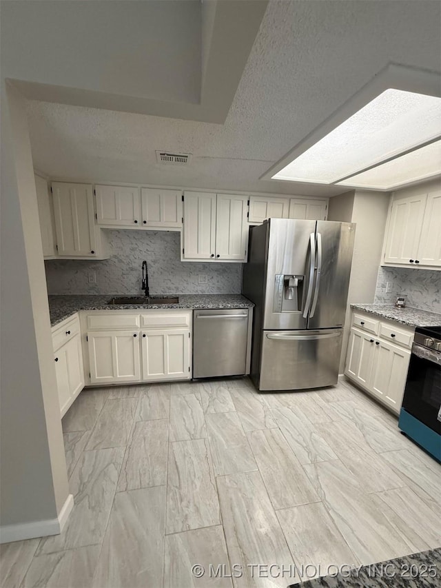 2800 E Seattle St, Broken Arrow, OK 74014 - kitchen featuring stainless steel appliances, a sink, stone counters, light marble finish flooring, and backsplash