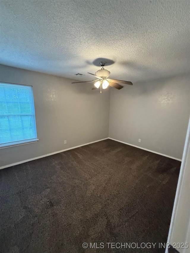 2800 E Seattle St, Broken Arrow, OK 74014 - empty room featuring a ceiling fan, dark carpet, baseboards, and a textured ceiling