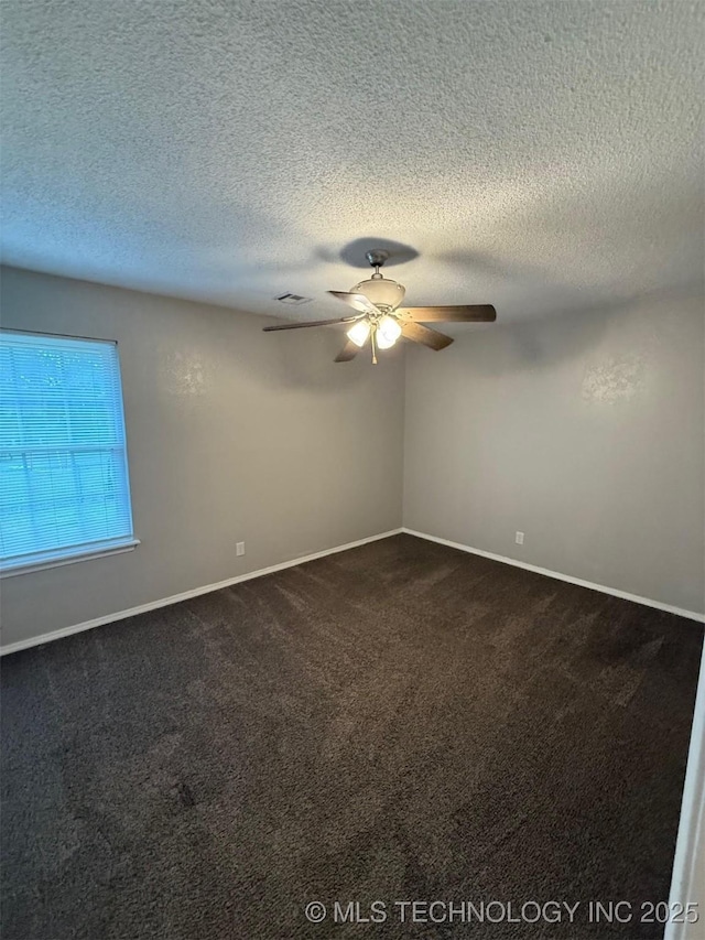 2800 E Seattle St, Broken Arrow, OK 74014 - spare room featuring ceiling fan, dark carpet, a textured ceiling, and baseboards