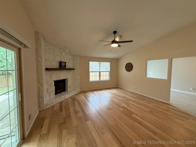 2800 E Seattle St, Broken Arrow, OK 74014 - unfurnished living room featuring vaulted ceiling, ceiling fan, light wood-style flooring, a fireplace, and baseboards