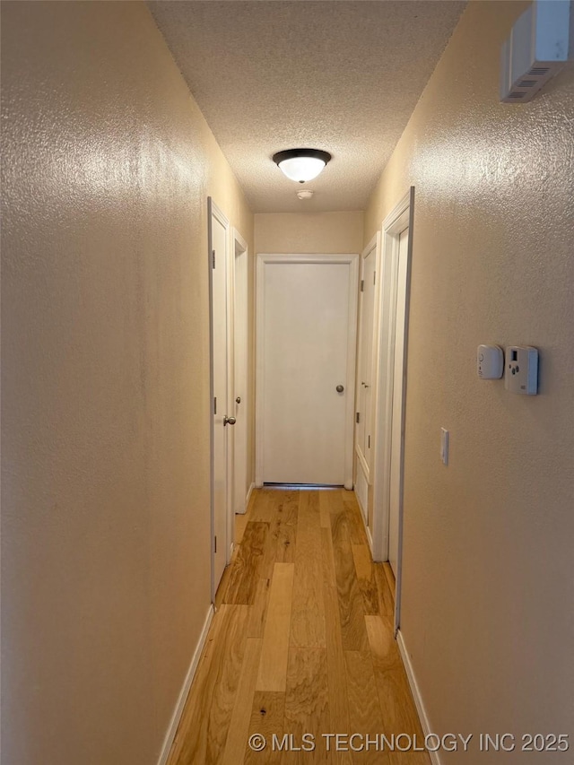 2800 E Seattle St, Broken Arrow, OK 74014 - hallway with light wood-type flooring, a textured ceiling, and baseboards
