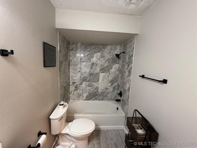 2800 E Seattle St, Broken Arrow, OK 74014 - bathroom with toilet, washtub / shower combination, wood finished floors, and a textured ceiling