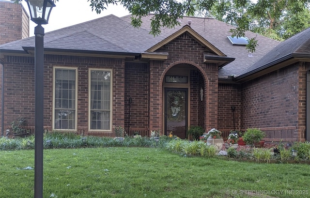 11309 S 107th E Ave, Bixby, OK 74008 - property entrance featuring brick siding, a yard, and roof with shingles