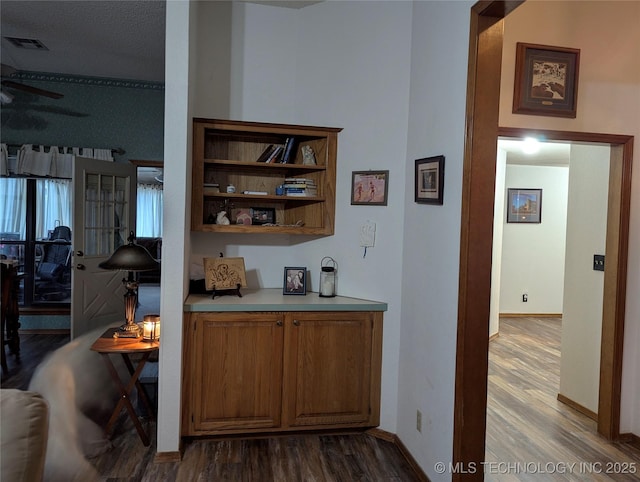 11309 S 107th E Ave, Bixby, OK 74008 - bar area with dark wood finished floors, ceiling fan, and baseboards
