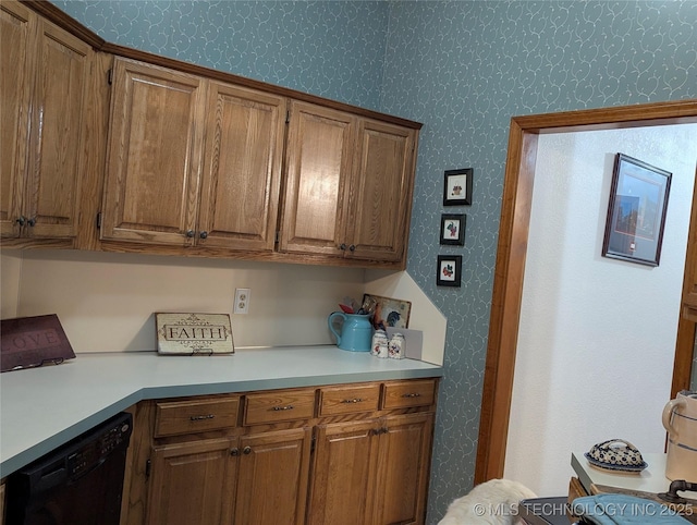 11309 S 107th E Ave, Bixby, OK 74008 - kitchen with wallpapered walls, dishwasher, light countertops, and brown cabinetry
