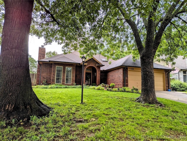 11309 S 107th E Ave, Bixby, OK 74008 - view of front facade featuring brick siding, driveway, a chimney, a front yard, and an attached garage
