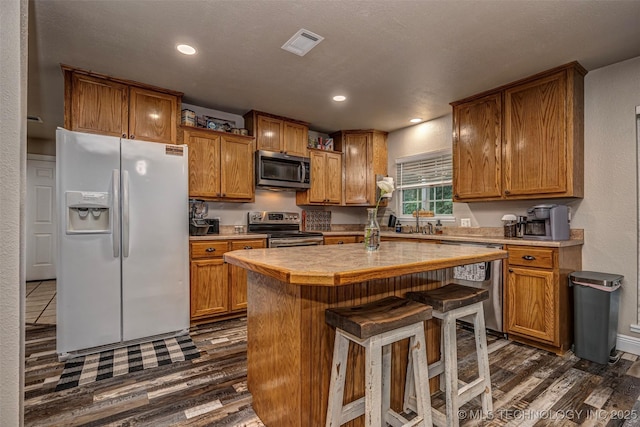 1319 SE 3rd St, Antlers, OK 74523 - kitchen featuring stainless steel appliances, light countertops, brown cabinetry, and recessed lighting