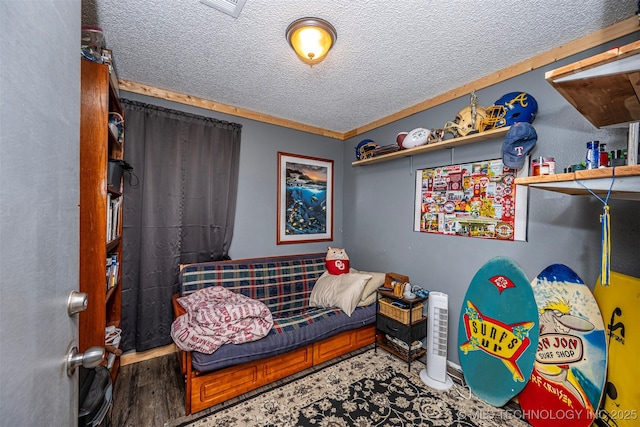 1319 SE 3rd St, Antlers, OK 74523 - bedroom with a textured ceiling and wood finished floors