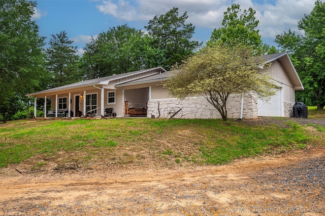 1319 SE 3rd St, Antlers, OK 74523 - back of property featuring an attached garage, dirt driveway, stone siding, and a porch