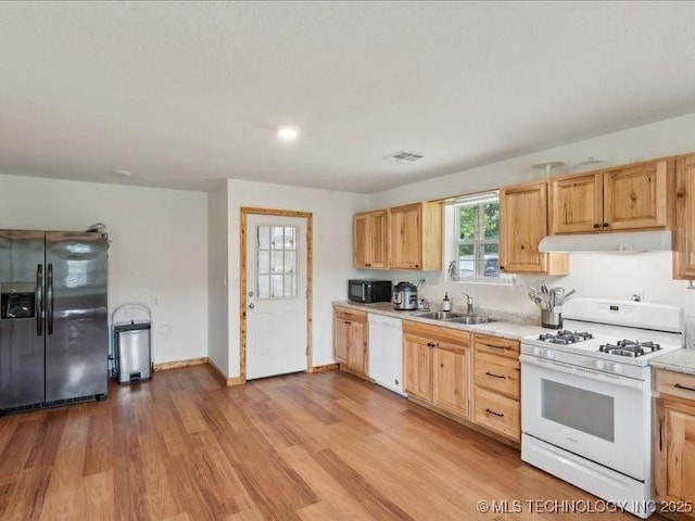 25301 E 330th Rd, Chelsea, OK 74016 - kitchen featuring white appliances, under cabinet range hood, a sink, light countertops, and light wood finished floors