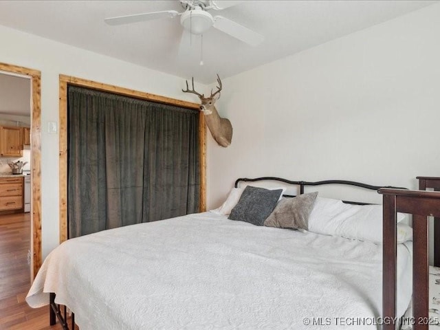 25301 E 330th Rd, Chelsea, OK 74016 - bedroom with wood finished floors and ceiling fan