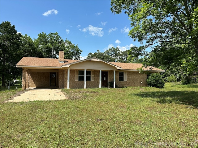 9871 E Windy Ln, Lane, OK 74555 - rear view of house with a lawn, a carport, a chimney, and brick siding