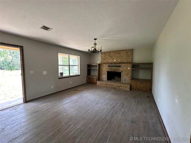 9871 E Windy Ln, Lane, OK 74555 - unfurnished living room with a chandelier, wood finished floors, and baseboards