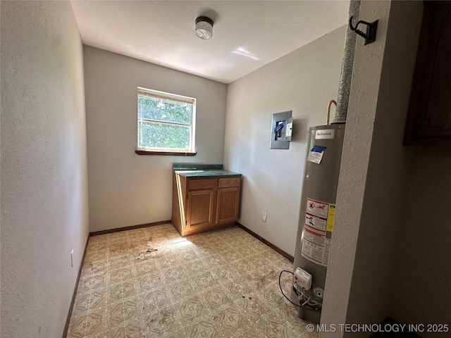 9871 E Windy Ln, Lane, OK 74555 - washroom featuring gas water heater, baseboards, light floors, and electric panel