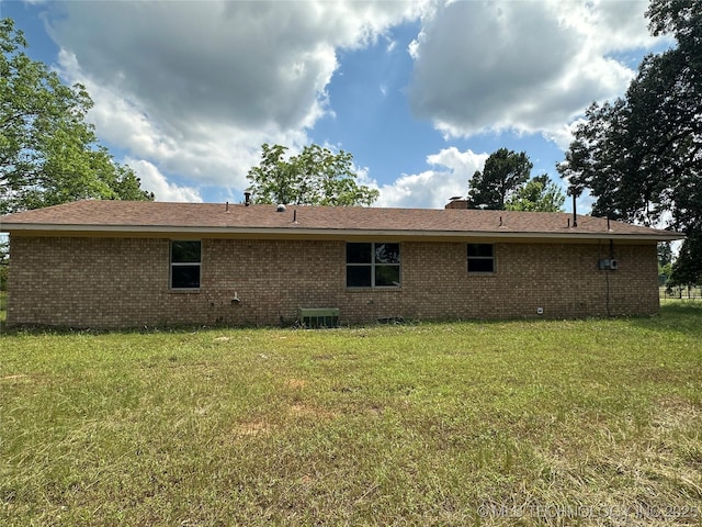 9871 E Windy Ln, Lane, OK 74555 - back of house with brick siding, a lawn, and a chimney