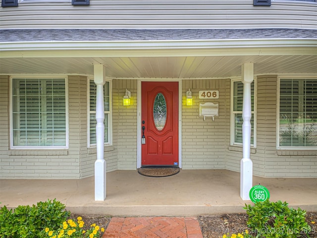 406 Sequoyah Trl, Norman, OK 73071 - entrance to property featuring brick siding, covered porch, and roof with shingles