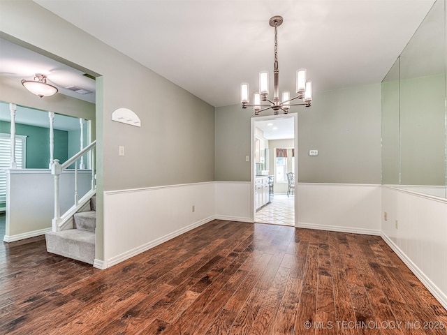 406 Sequoyah Trl, Norman, OK 73071 - empty room featuring wood-type flooring, a chandelier, stairway, and baseboards
