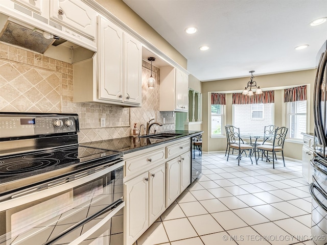 406 Sequoyah Trl, Norman, OK 73071 - kitchen featuring range with two ovens, under cabinet range hood, decorative backsplash, white cabinetry, and recessed lighting