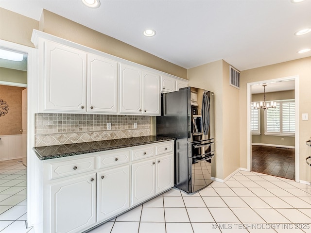406 Sequoyah Trl, Norman, OK 73071 - kitchen with black refrigerator with ice dispenser, a chandelier, white cabinetry, tasteful backsplash, and recessed lighting