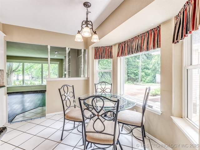 406 Sequoyah Trl, Norman, OK 73071 - dining room featuring baseboards, light tile patterned floors, and a chandelier