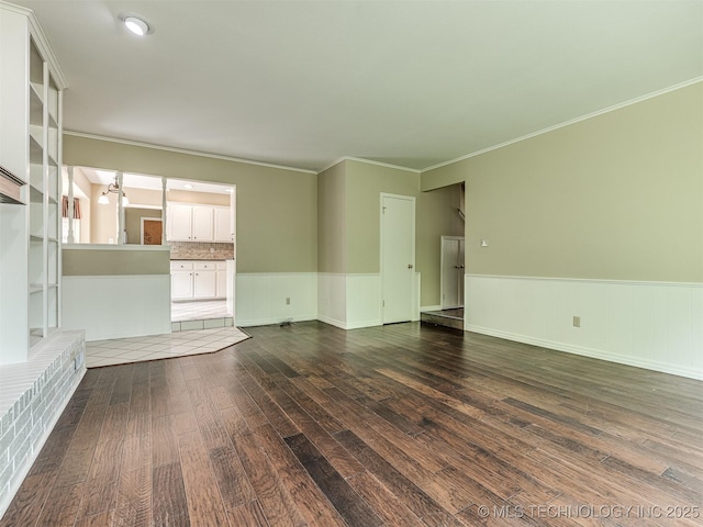 406 Sequoyah Trl, Norman, OK 73071 - unfurnished living room with dark wood finished floors, wainscoting, and ornamental molding