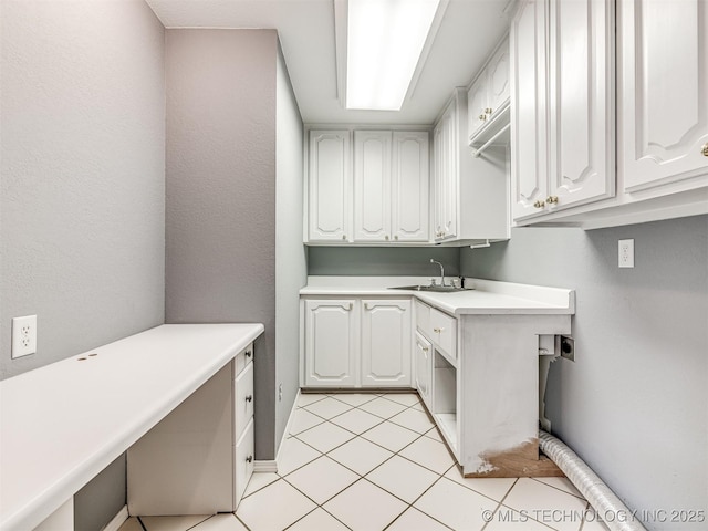 406 Sequoyah Trl, Norman, OK 73071 - laundry area featuring cabinet space, light tile patterned floors, and hookup for an electric dryer