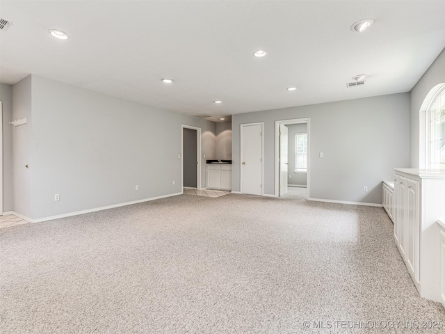 406 Sequoyah Trl, Norman, OK 73071 - unfurnished living room featuring recessed lighting, baseboards, and light carpet