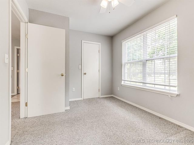 406 Sequoyah Trl, Norman, OK 73071 - unfurnished bedroom with light colored carpet, baseboards, and a ceiling fan