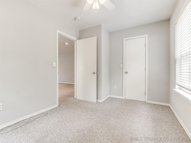 406 Sequoyah Trl, Norman, OK 73071 - unfurnished bedroom with multiple windows, carpet flooring, and a ceiling fan