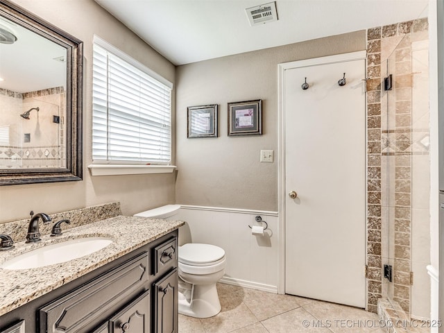 406 Sequoyah Trl, Norman, OK 73071 - full bathroom featuring toilet, vanity, a stall shower, tile patterned floors, and wainscoting