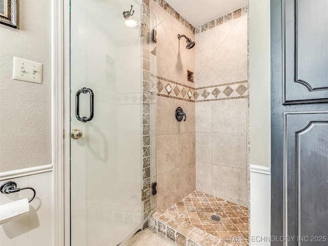 406 Sequoyah Trl, Norman, OK 73071 - bathroom featuring a stall shower and a wainscoted wall