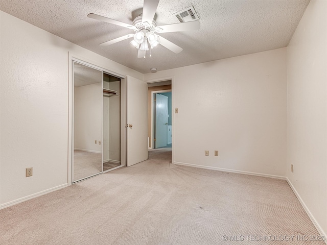 406 Sequoyah Trl, Norman, OK 73071 - unfurnished bedroom with light colored carpet, a textured ceiling, a ceiling fan, a closet, and baseboards