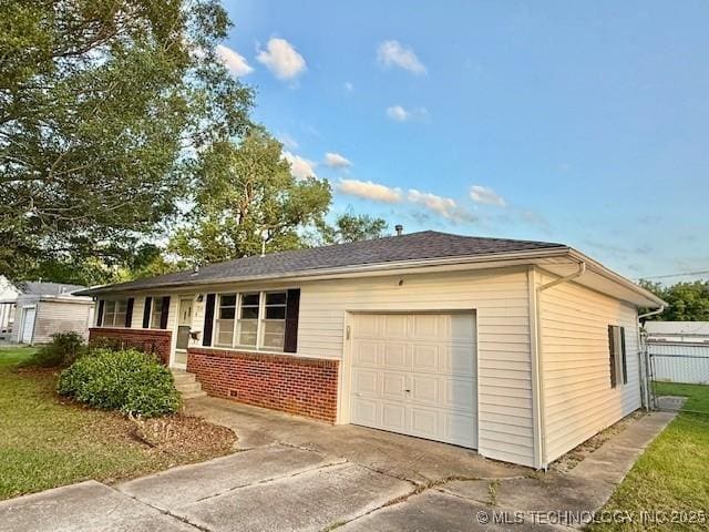1714 E 11th St, Okmulgee, OK 74447 - view of front of home featuring concrete driveway, a garage, and brick siding