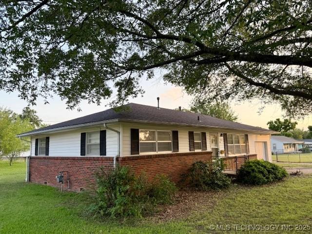 1714 E 11th St, Okmulgee, OK 74447 - view of home's exterior with brick siding