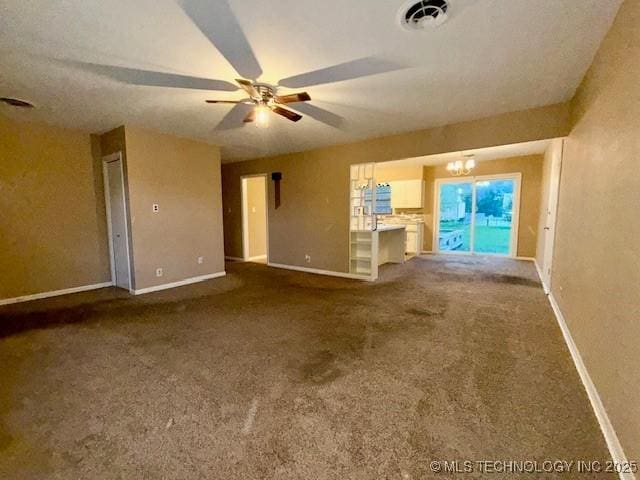 1714 E 11th St, Okmulgee, OK 74447 - unfurnished living room with baseboards, carpet, and ceiling fan