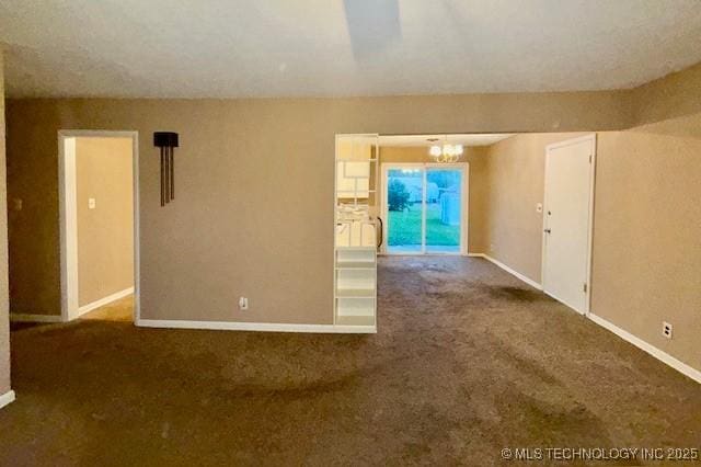 1714 E 11th St, Okmulgee, OK 74447 - spare room featuring carpet, a chandelier, and baseboards