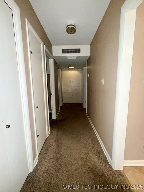1714 E 11th St, Okmulgee, OK 74447 - hallway featuring carpet and baseboards