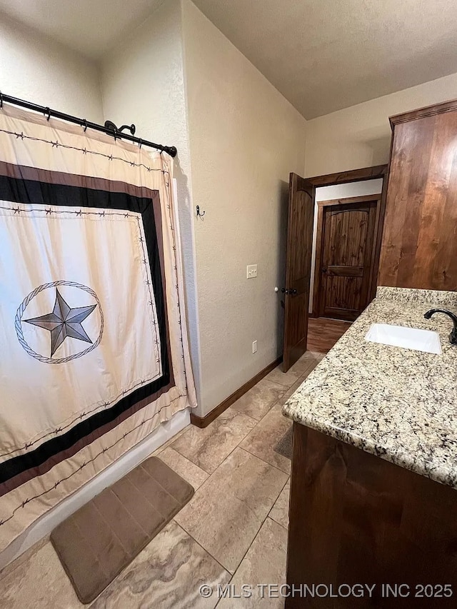 17 Zachary Taylor, Durant, OK 74701 - full bathroom with vanity, a shower with curtain, baseboards, and tile patterned flooring