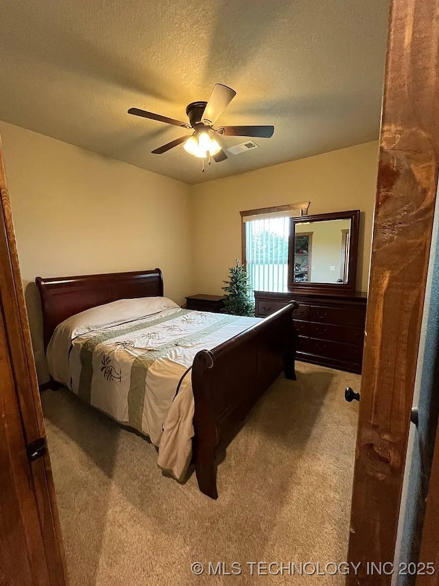 17 Zachary Taylor, Durant, OK 74701 - bedroom featuring carpet flooring, a textured ceiling, and a ceiling fan